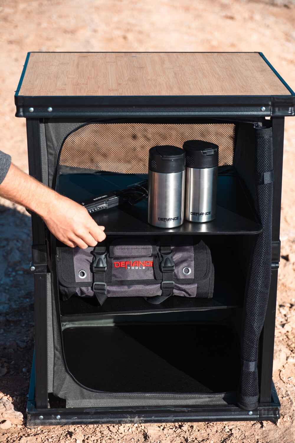 De-fiance folding camp table in use
